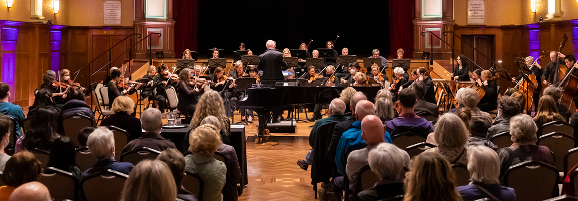 An audience watches an orchestra performing