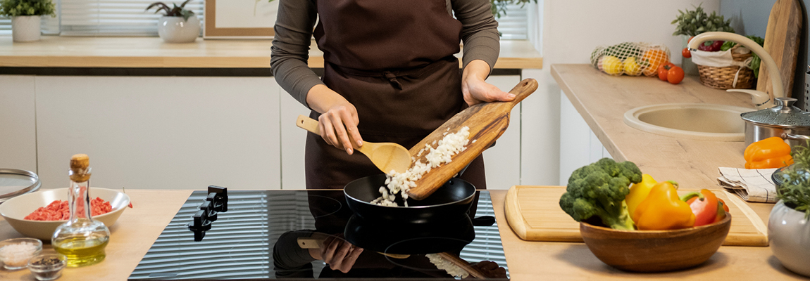 a person cooks on an induction stovetop