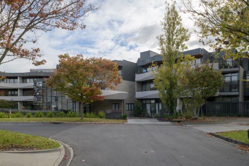 A 3-storey retirement living complex with trees out the front