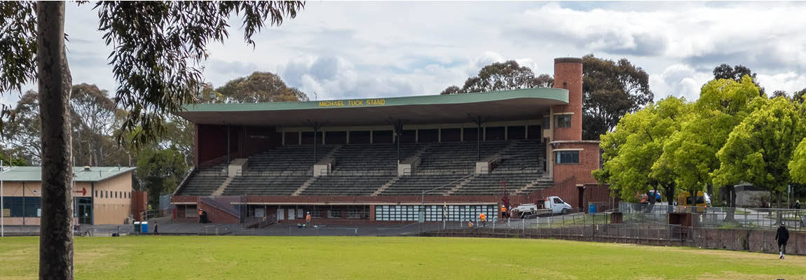 a heritage brick grandstand on a green sports oval