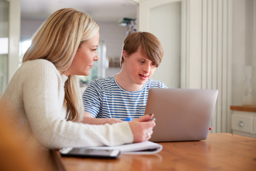A mother and son using a laptop