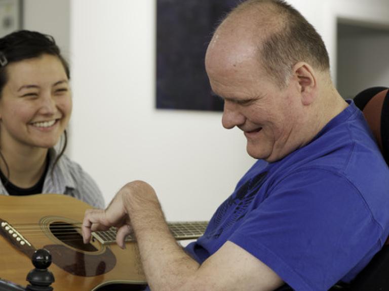 A man with disability and his support worker