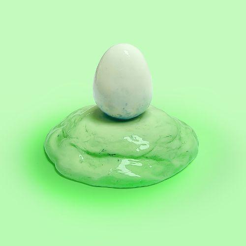 Ceramic sculpture of a white egg on a light green mound.
