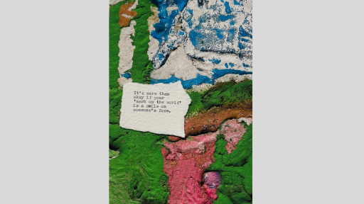 A piece of torn paper with a poem printed from a typewriter, sitting on a textured surface that is green, white, blue and pink colours that have blended together like liquid