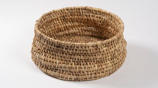 a round basket made by hand using reeds