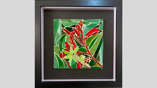 An artwork featuring a glass mosaic showing a red flower and a light green flower on a multi-shade green background