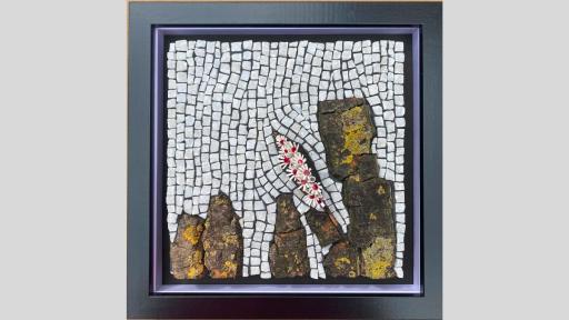 An artwork featuring a mosaic of white square stones with large natural stones with moss in columns along the base of the artwork and a small sprout of blossoms emerging from the rocks