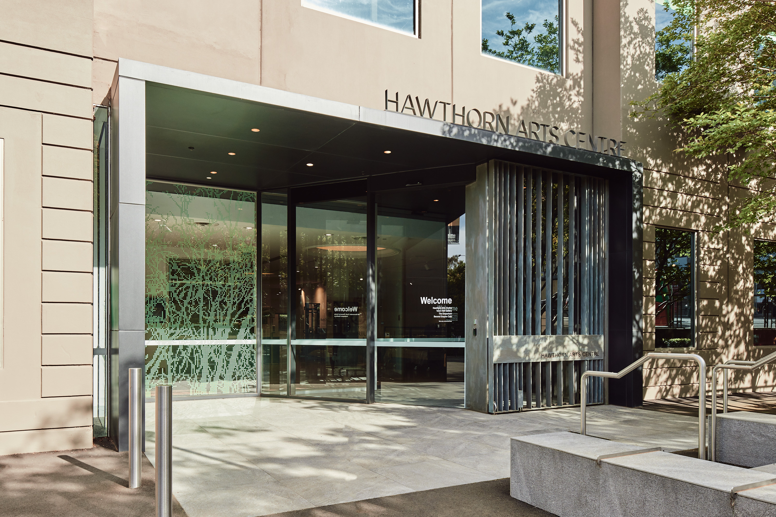 The entrance to the Hawthorn Arts Centre with a large sliding glass door in a modern entryway