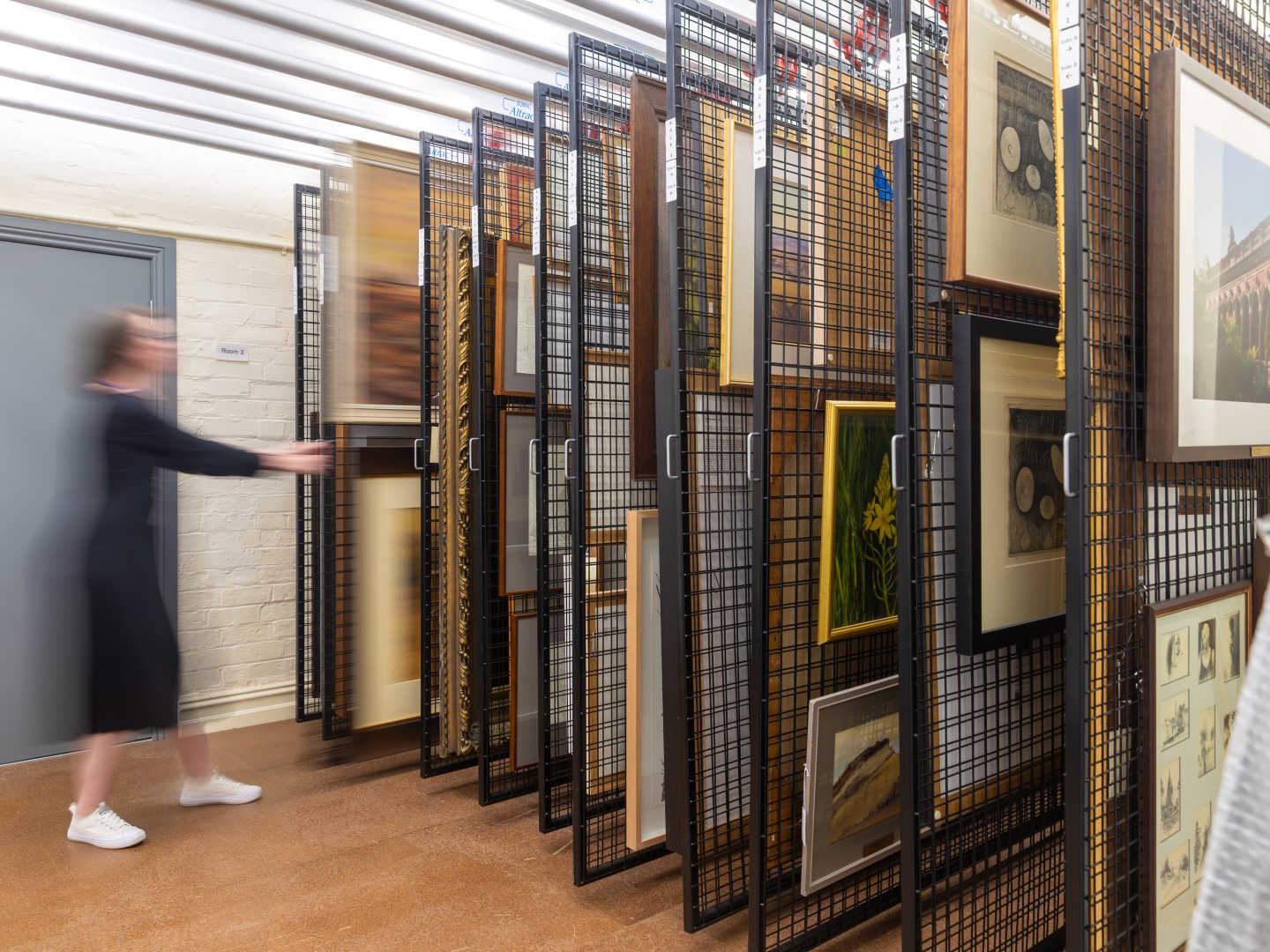 sliding racks filled with artwork from the Town Hall Gallery collection