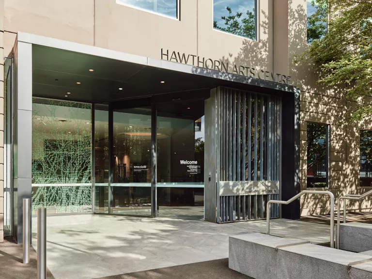 The entrance to the Hawthorn Arts Centre with a large sliding glass door in a modern entryway