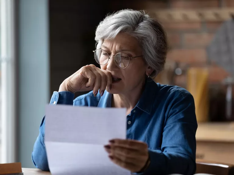 A person reading a letter