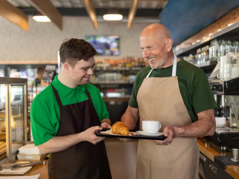 Two people working at a cafe together