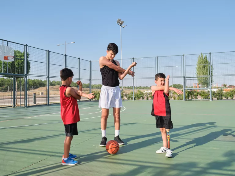 3 people playing basketball