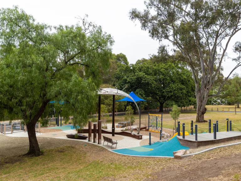 a small playground in a bush setting