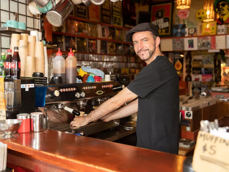 Young hipster pulling coffee at a cafe