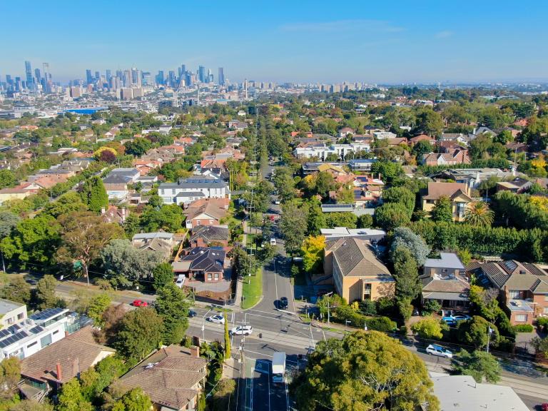 arial view of suburban houses and streets above Kew, looking towards the city