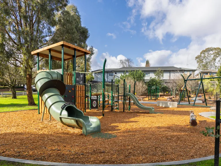 a small playground with a covered slide