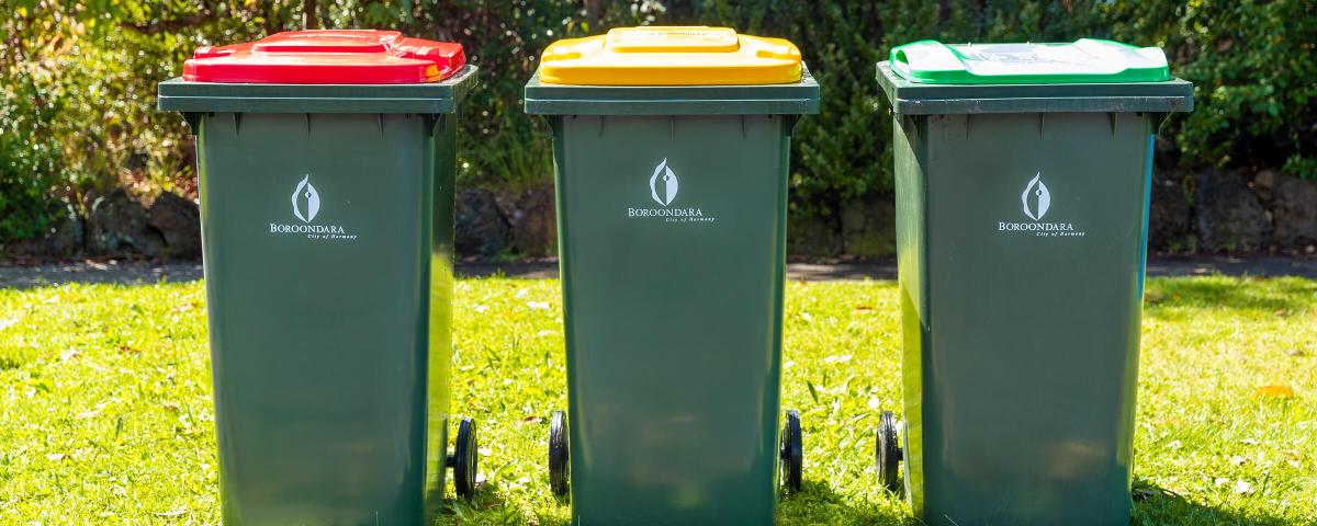 a set of 3 boroondara waste bins sitting on a nature strip