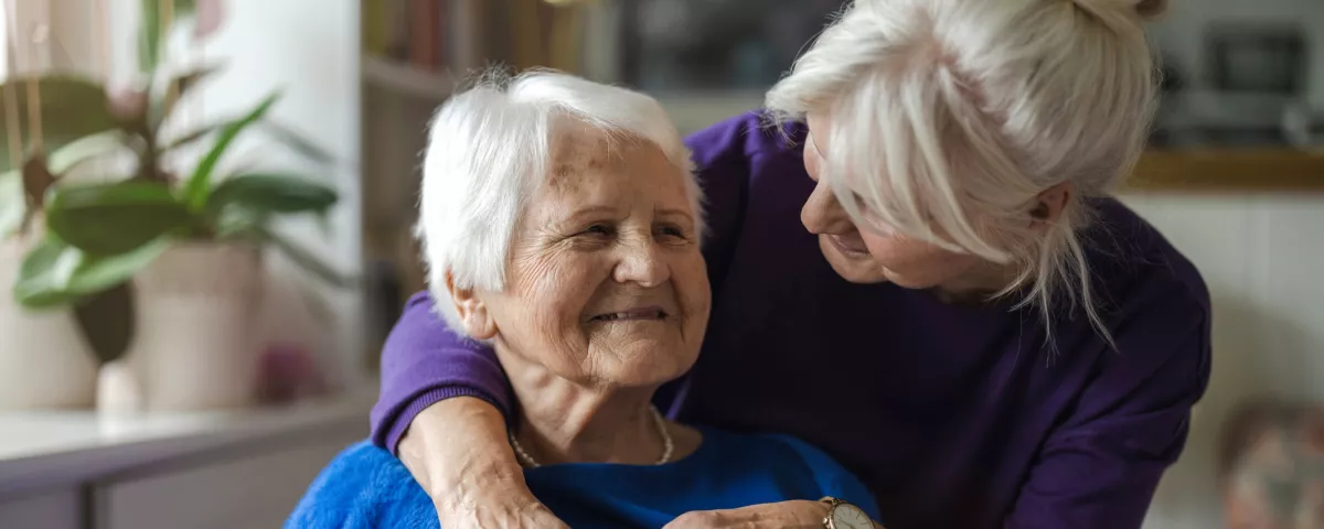 two older adults embracing