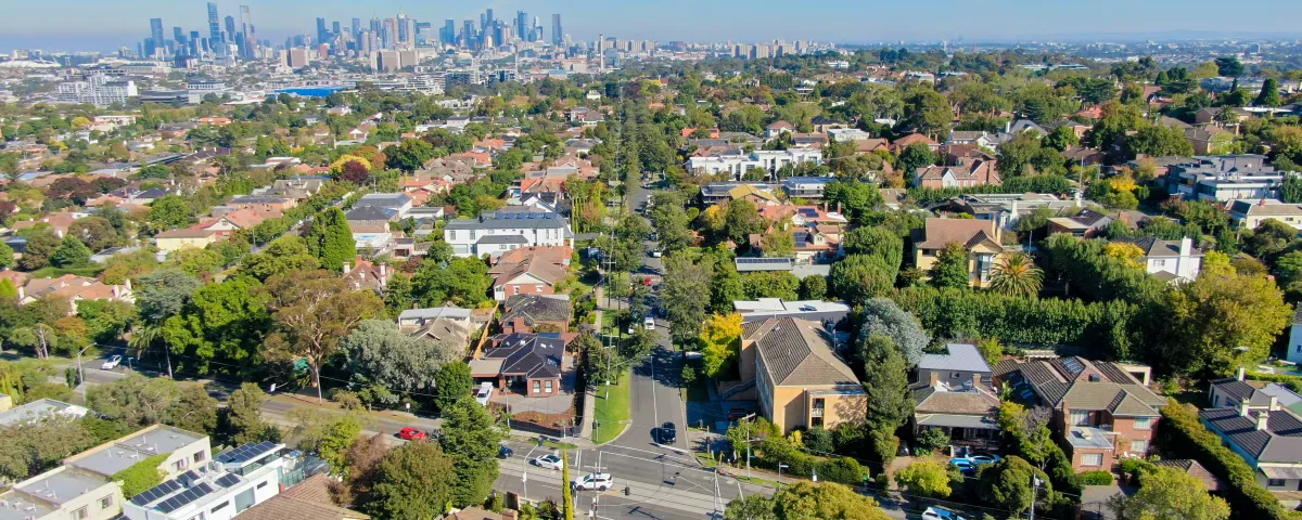 arial view of suburban houses and streets above Kew, looking towards the city