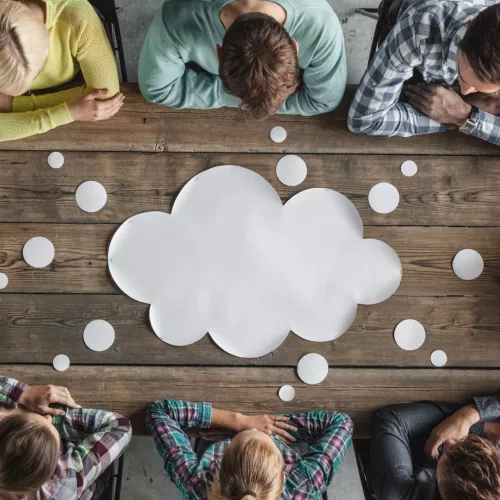 Group of people sitting around a table thinking