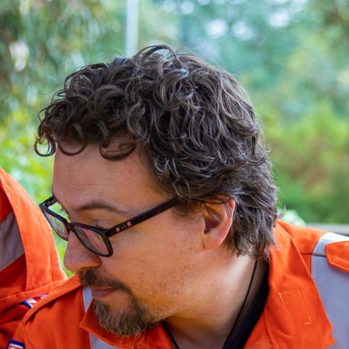 an adult and 2 small children wearing high-vis safety outfits