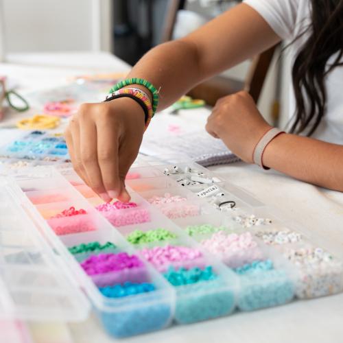 Making friendship bracelet using colourful beads