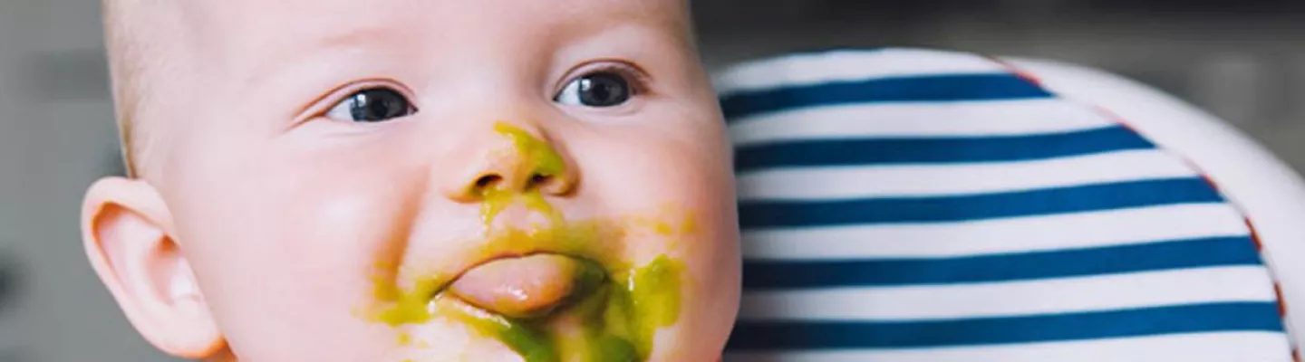  Baby in a high chair being fed