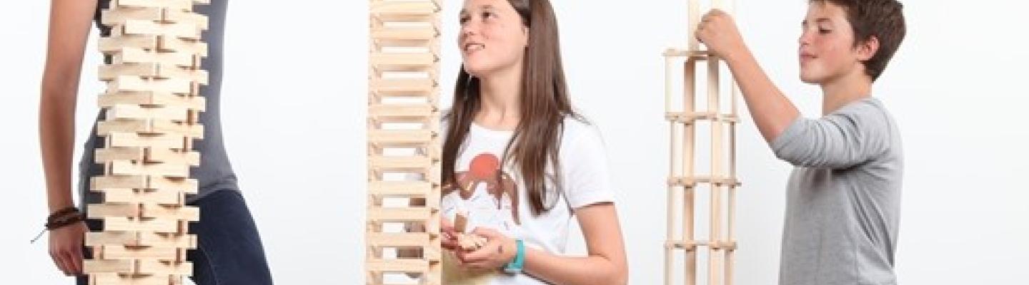 Three children building towers from blocks