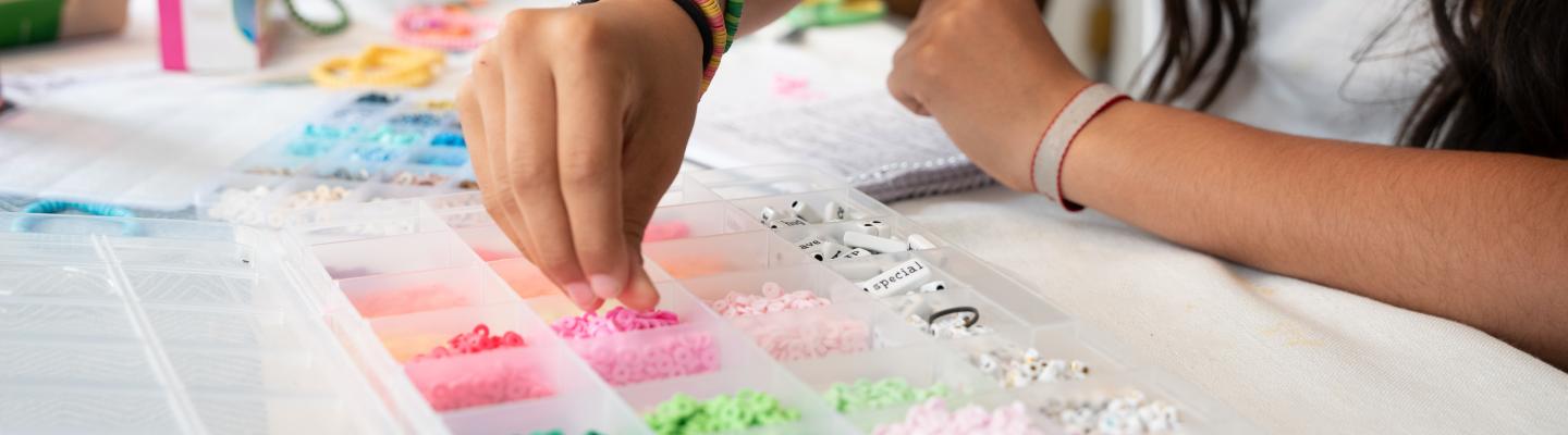 Making friendship bracelet using colourful beads