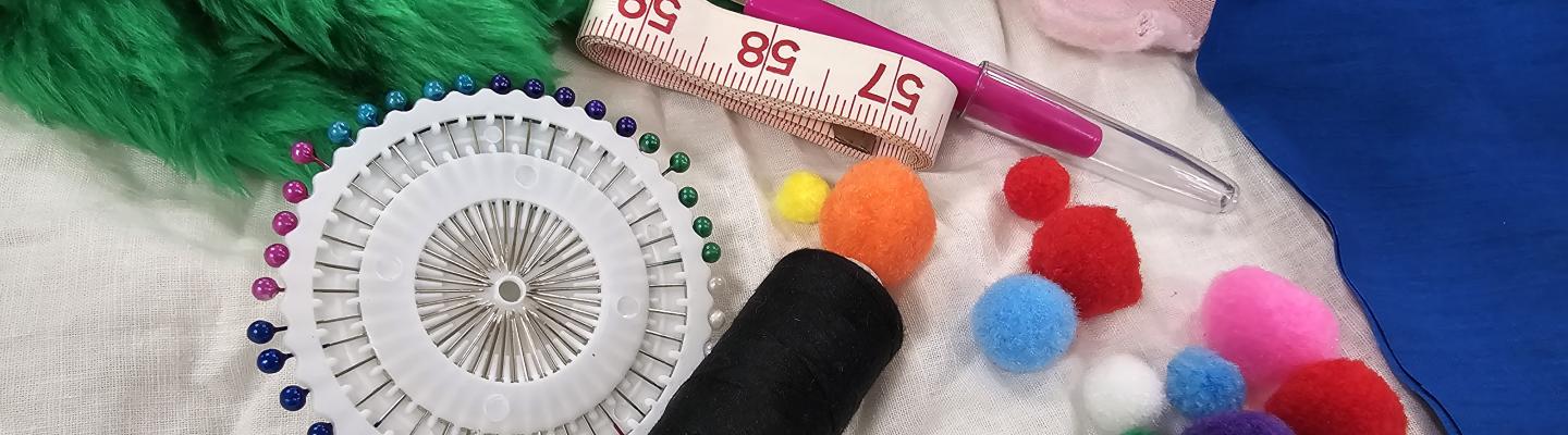 a tape measure, pins and other sewing notions on top of fake fur fabric