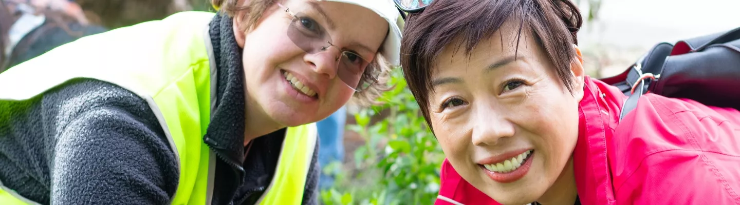 Two women of differing ethnicity in a garden