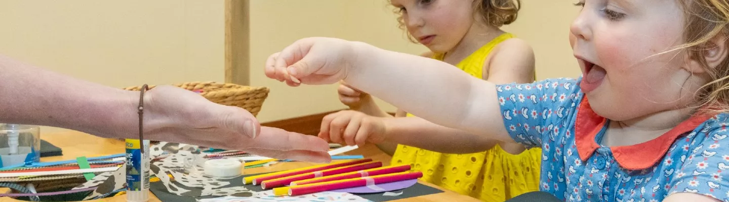 two kids drawing and making art