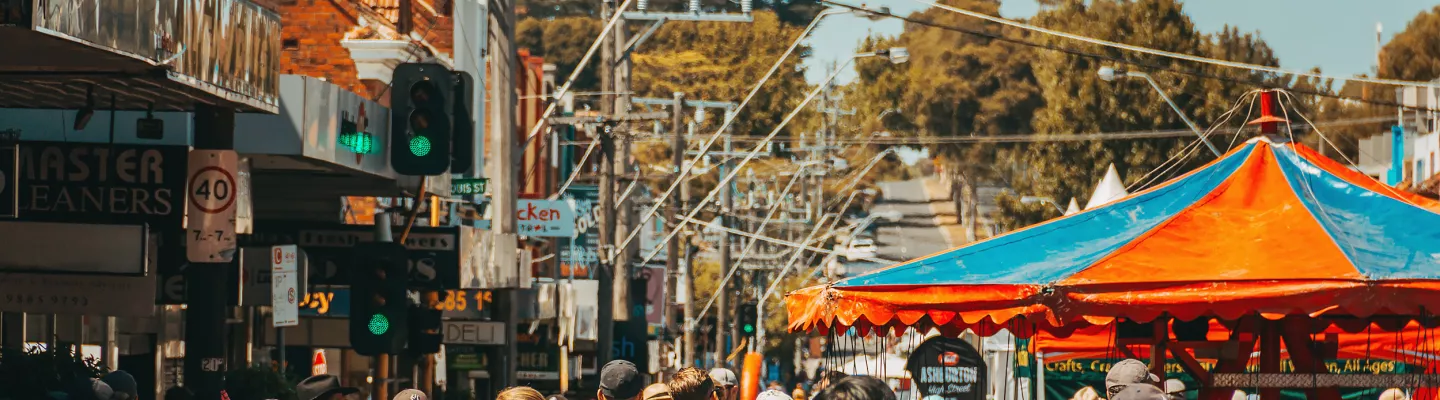 Colourful awnings and lots of people at a street festival