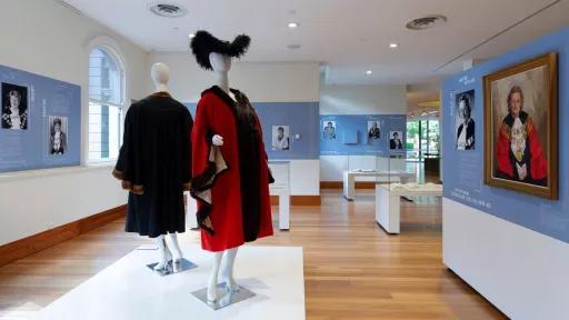 View of the Tracing Her Steps installation with two mannequins dressed in mayoral robes in the foreground