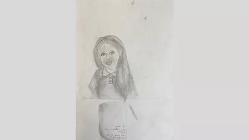 Graphite drawing of a girl sitting at a desk. She has a pencil and paper in front of her. She has long loose hair, is wearing a headband and is smiling.