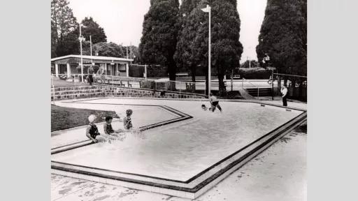 Children playing in a wading pool.