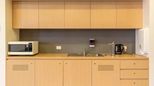 A tidy little kitchenette with microwave and sink