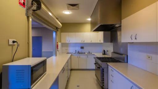 A kitchen with microwave and lots of bench space