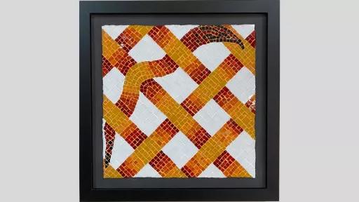 An artwork featuring a mosaic with diagonally thatched strips that are red, orange and yellow, and one diagonal strip is wavy like a snake