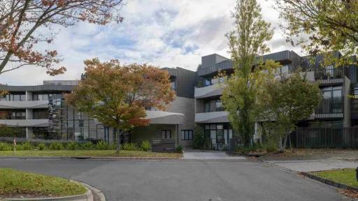 Sinuous, streamlined concrete apartments on a curving road