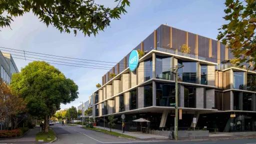 Concrete and glass corner-block building with a blue circular sign saying 'Xero'