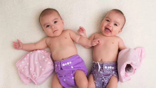 Two babies in reusable nappies