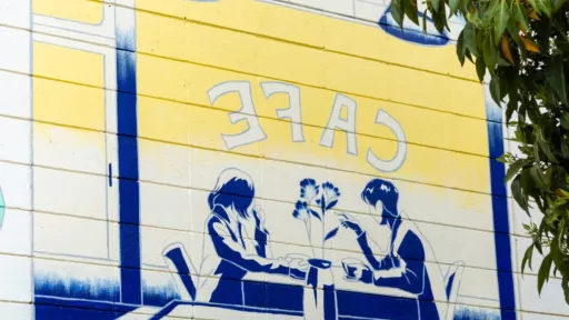 A mural showing two people sitting together in a cafe