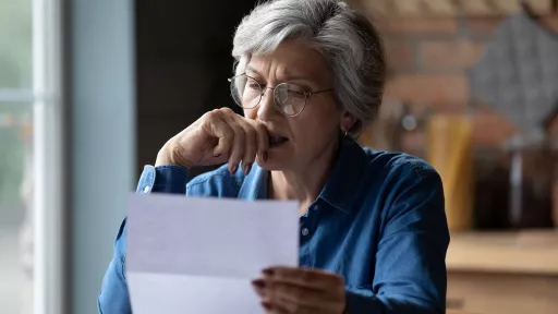 A person reading a letter