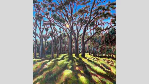 Painting of a green grassy field filled with tall trees against a blue sky. The sun is in the background so that there is a glowing red outline behind each of the trees and shadows cast on the grass, directed towards the foreground