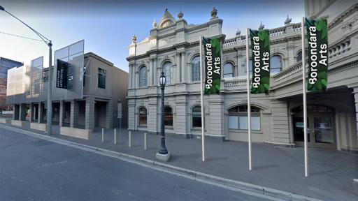 Front view of Hawthorn Arts Centre with bollards, benches and banner poles.