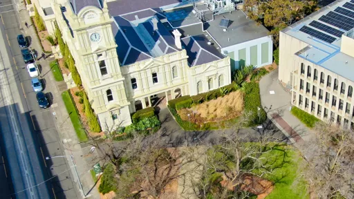 Overhead photo shows Boroondara Civic Precinct with Camberwell Road at left and trees in foreground.