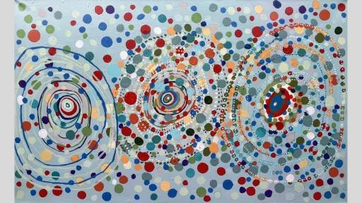 Painting of 3 large circles made up of individual rings within them. Throughout the painting are variously coloured dots.