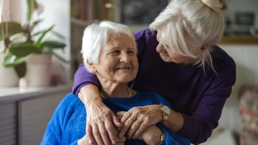 two older adults embracing